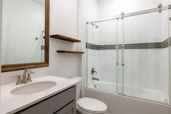 a bathroom with a sink toilet and shower