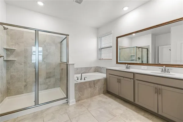 a spacious bathroom with a shower sink vanity and mirror