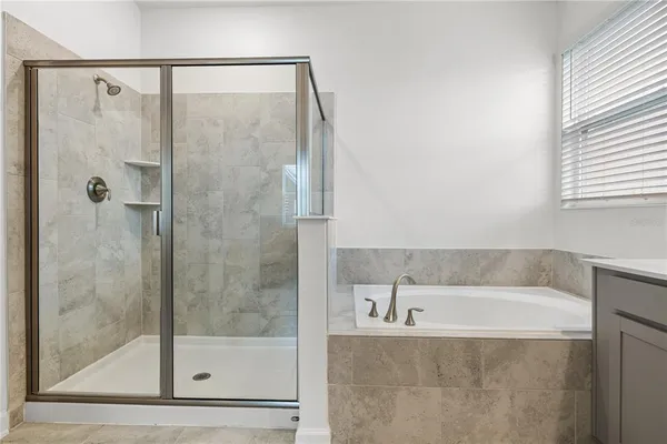 a bathroom with a bathtub and a shower