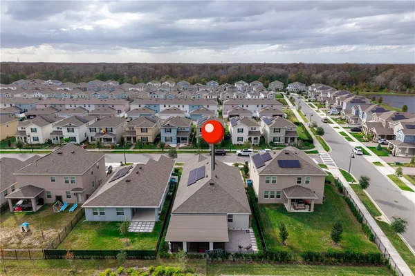 an aerial view of multiple houses with a yard