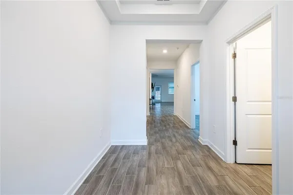 a view of a room with wooden floor
