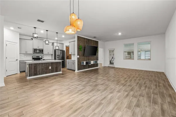 a view of a kitchen with cabinets and wooden floor