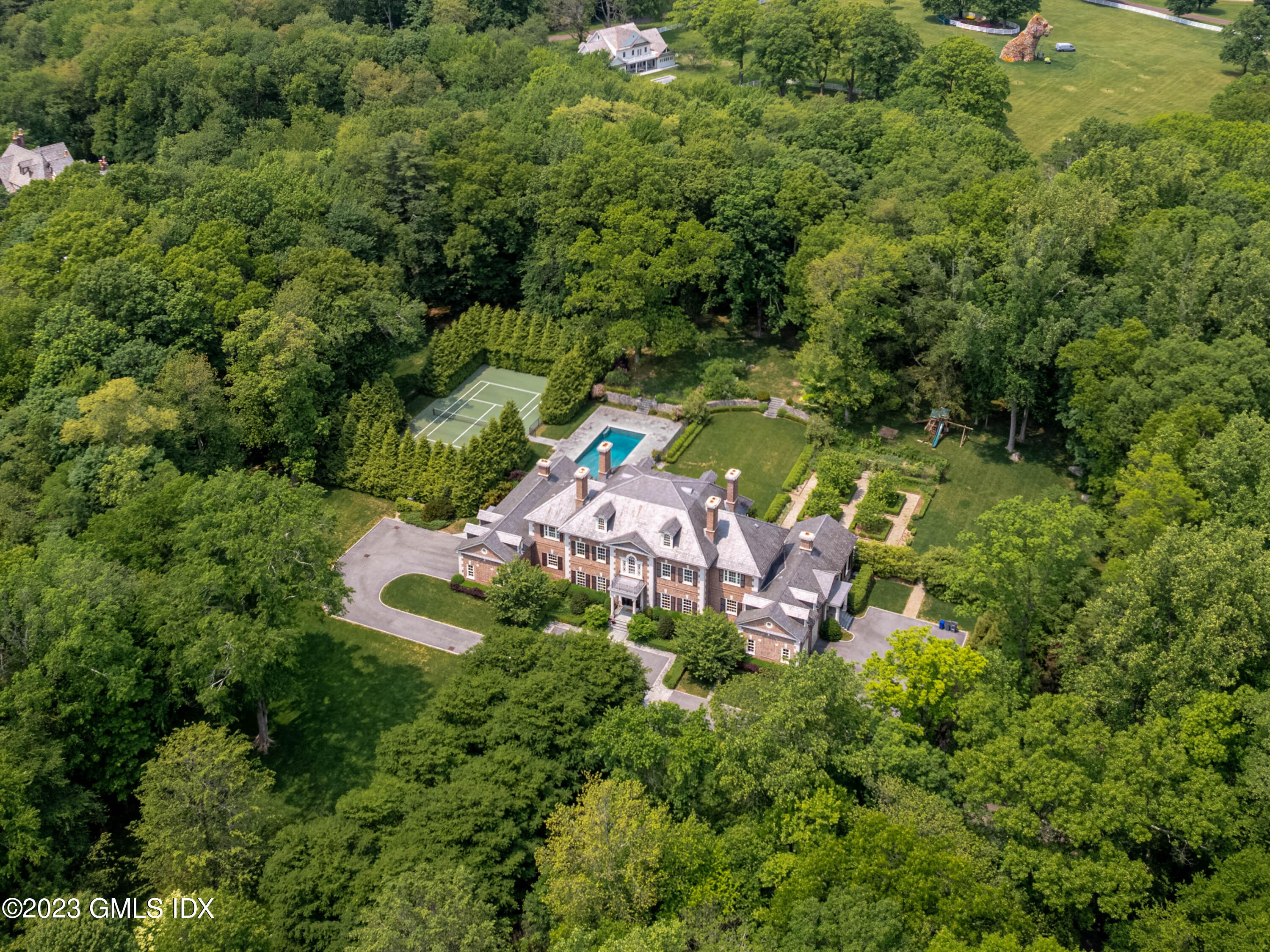 an aerial view of a house with a yard and outdoor seating