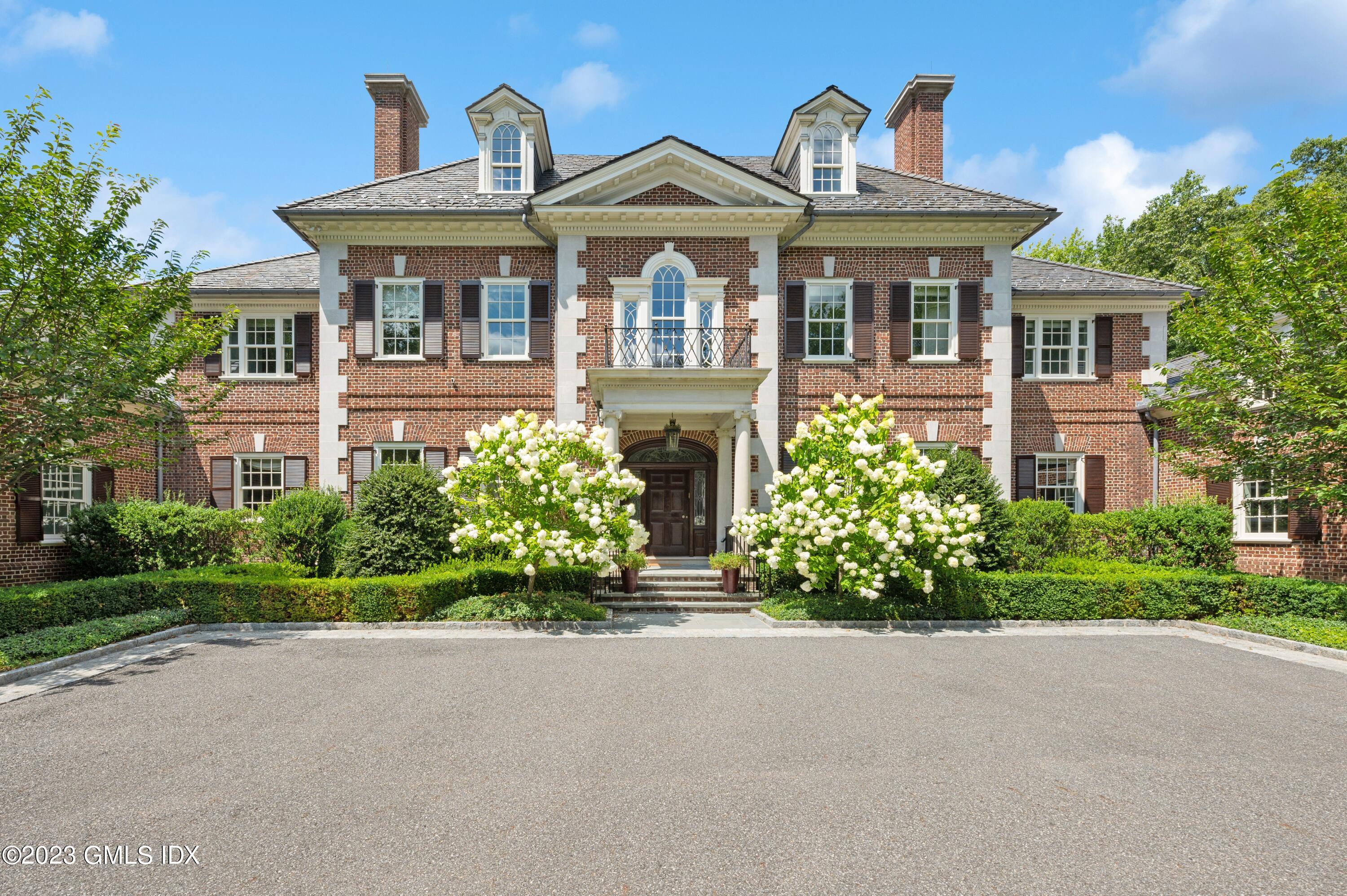 3 Hekma Road Greenwich, CT 06831 - Photo 2 of 6 a front view of a house with a garden