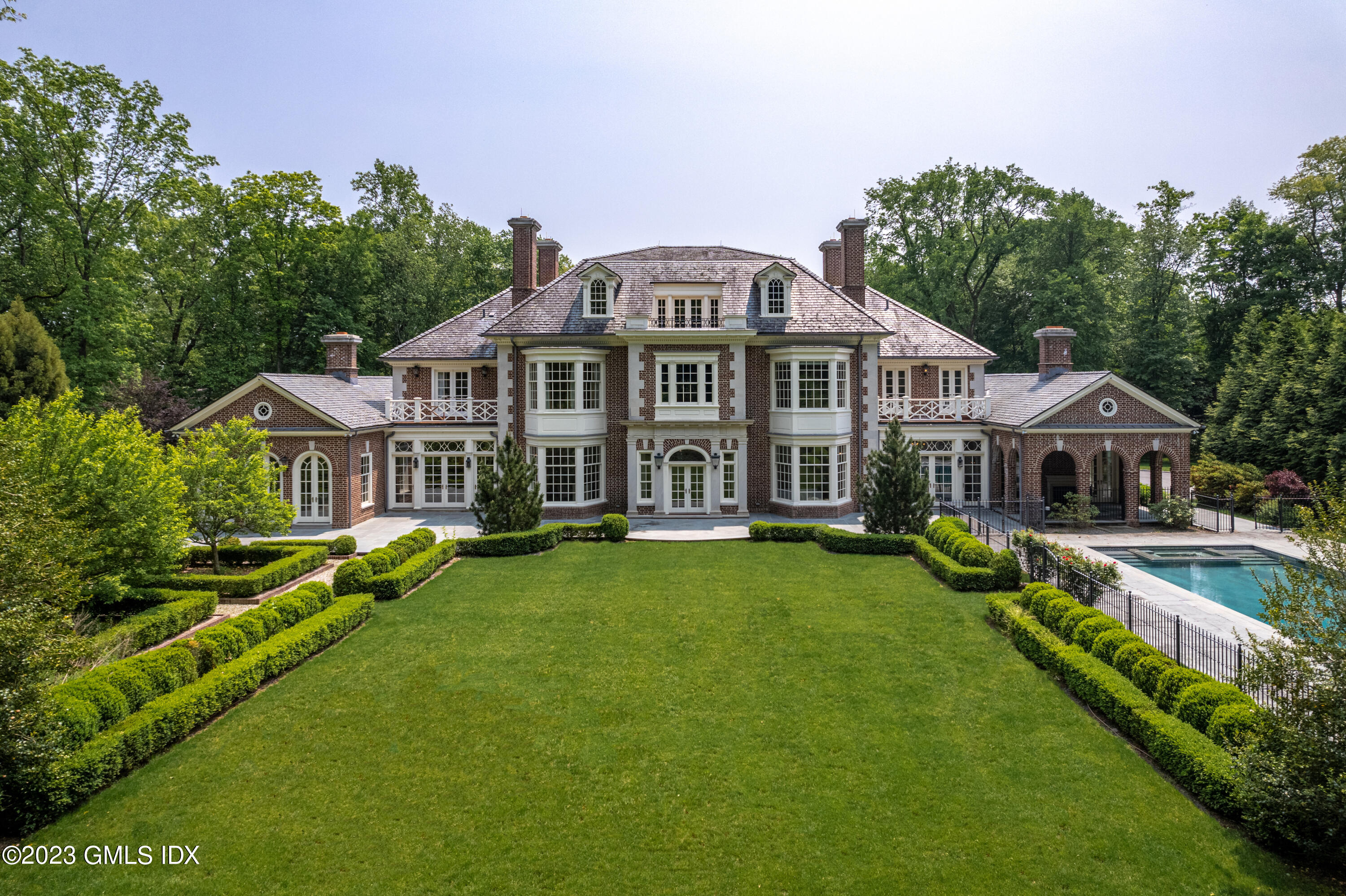 3 Hekma Road Greenwich, CT 06831 - Photo 4 of 6 a view of a house with a big yard and large trees