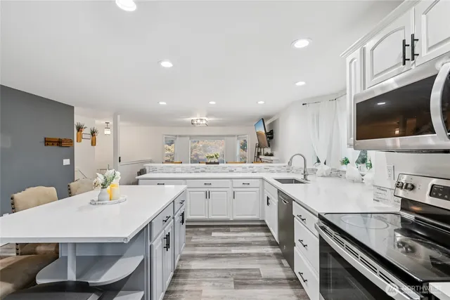 a kitchen with a sink stove and microwave