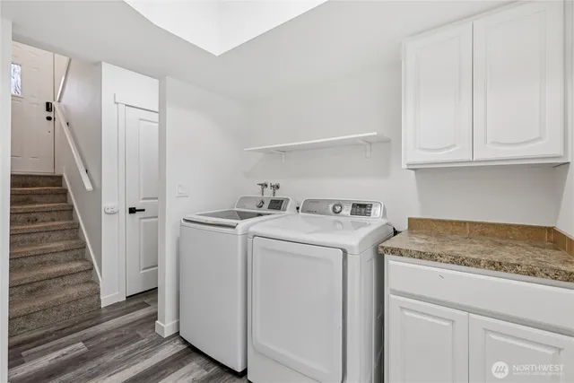 a bathroom with a granite countertop sink a mirror and shower