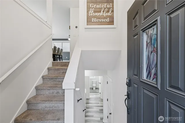 a view of entryway and hall with wooden floor