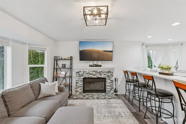 a living room with furniture a flat screen tv and a fireplace