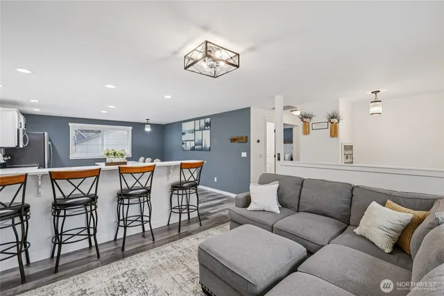 a living room with furniture a rug and a chandelier