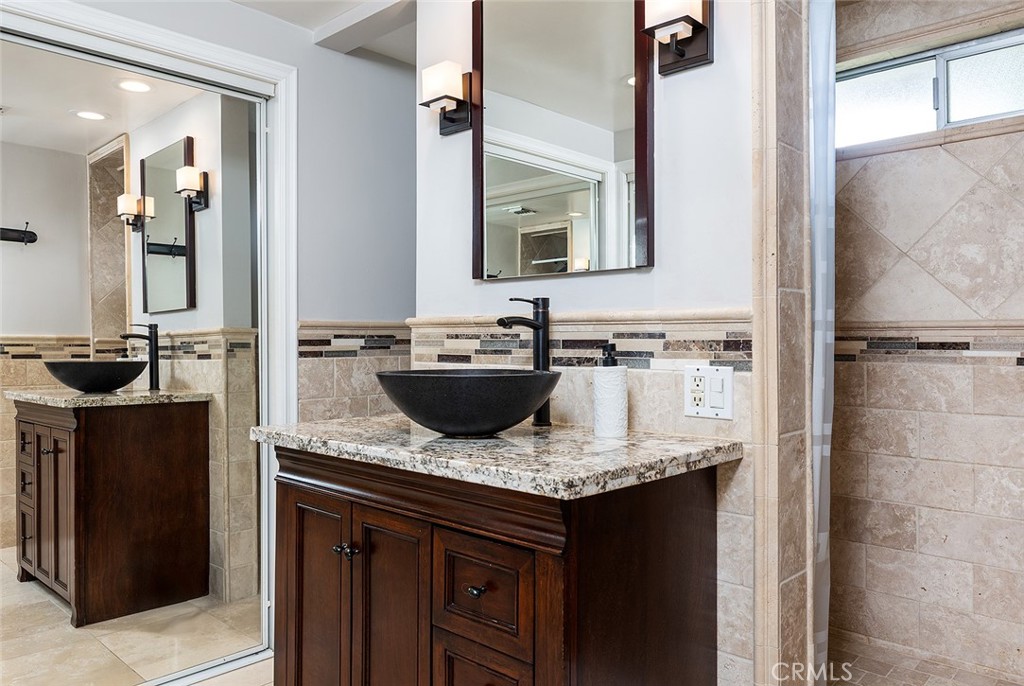 2212 Rim Road Duarte, CA 91008 - Photo 25 of 52 a bathroom with a granite countertop sink and a mirror
