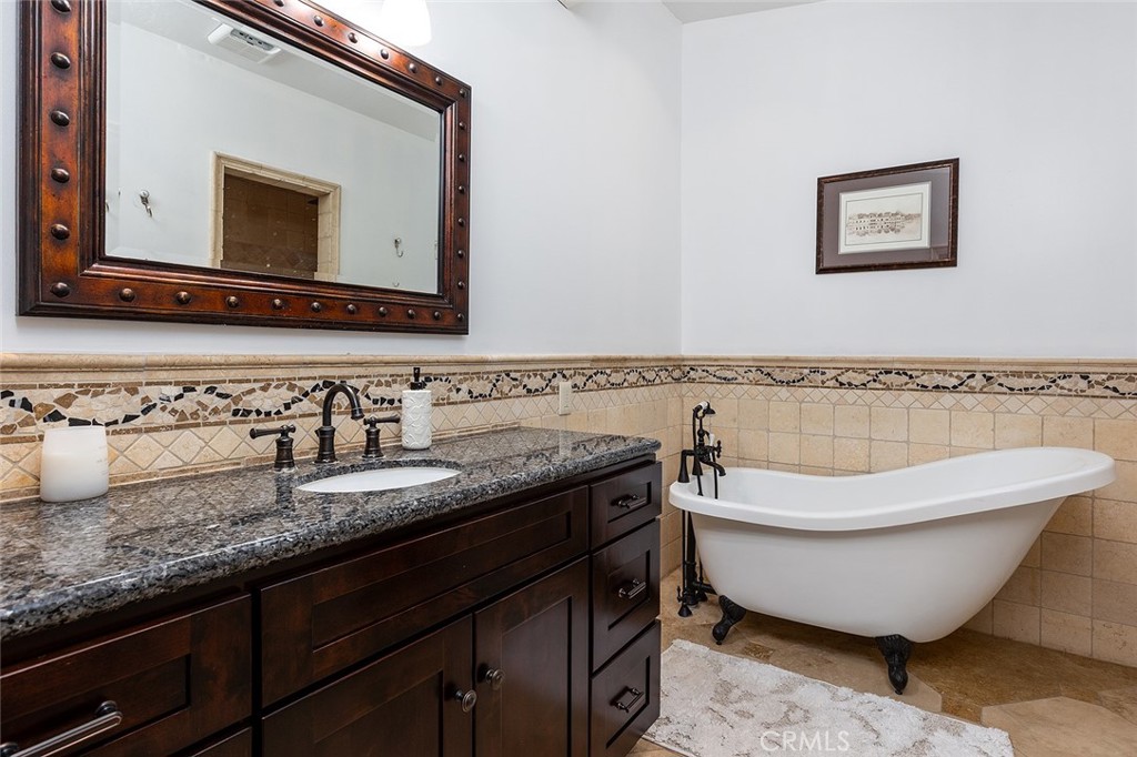 2212 Rim Road Duarte, CA 91008 - Photo 29 of 52 a spacious bathroom with a granite countertop sink and a mirror