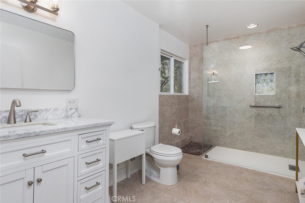 2212 Rim Road Duarte, CA 91008 - Photo 52 of 52 a bathroom with a granite countertop toilet sink and mirror