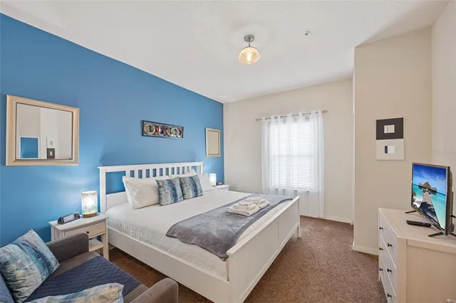 a bedroom with a bed and a couch