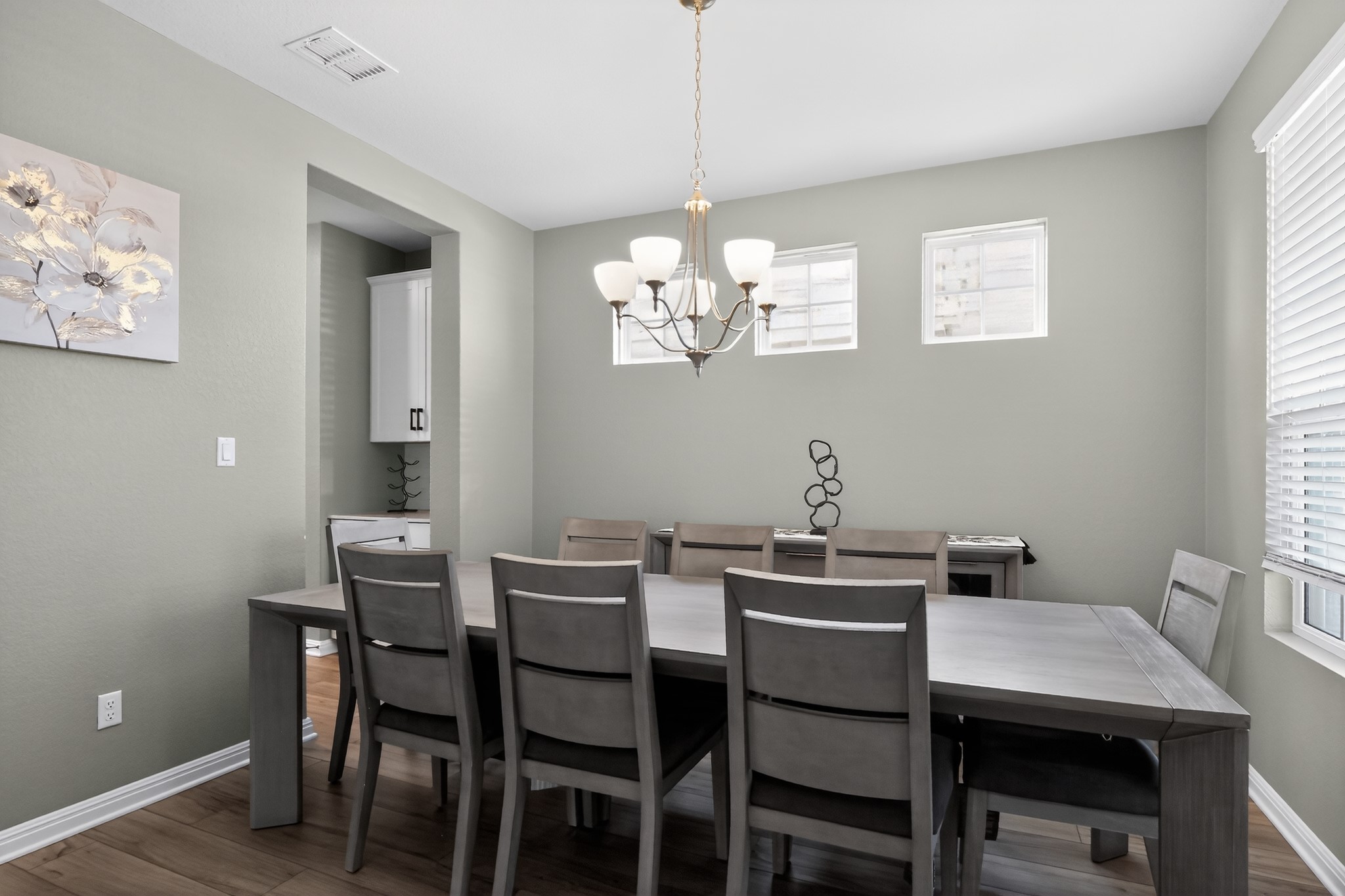 114 Bosco Road Hutto, TX 78634 - Photo 7 of 39 A classic chandelier illuminates the generously sized dining area, perfect for entertaining.