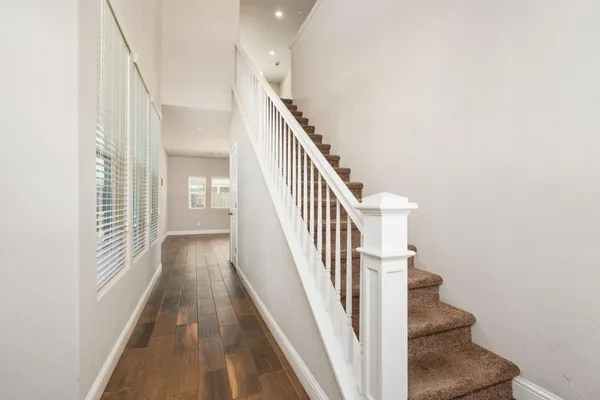 a view of entryway and hall with wooden floor