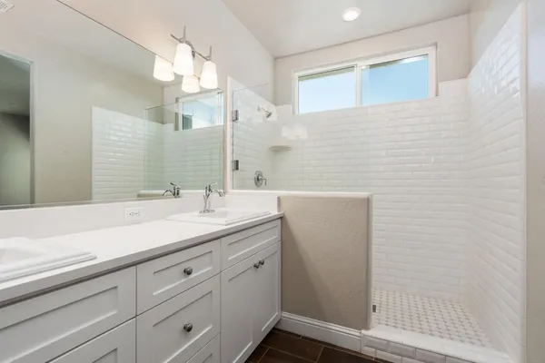 a bathroom with a granite countertop sink and a mirror