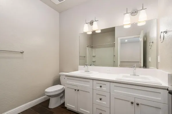 a bathroom with a toilet sink and mirror