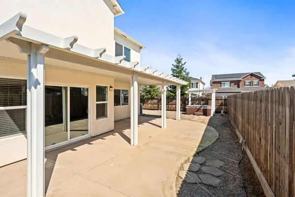 a view of a balcony with wooden floor and fence