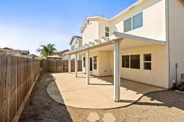 a building outdoor space with patio furniture and garden
