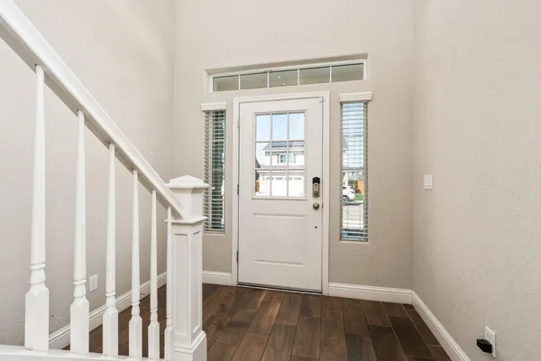a view of entryway with wooden floor and stairs