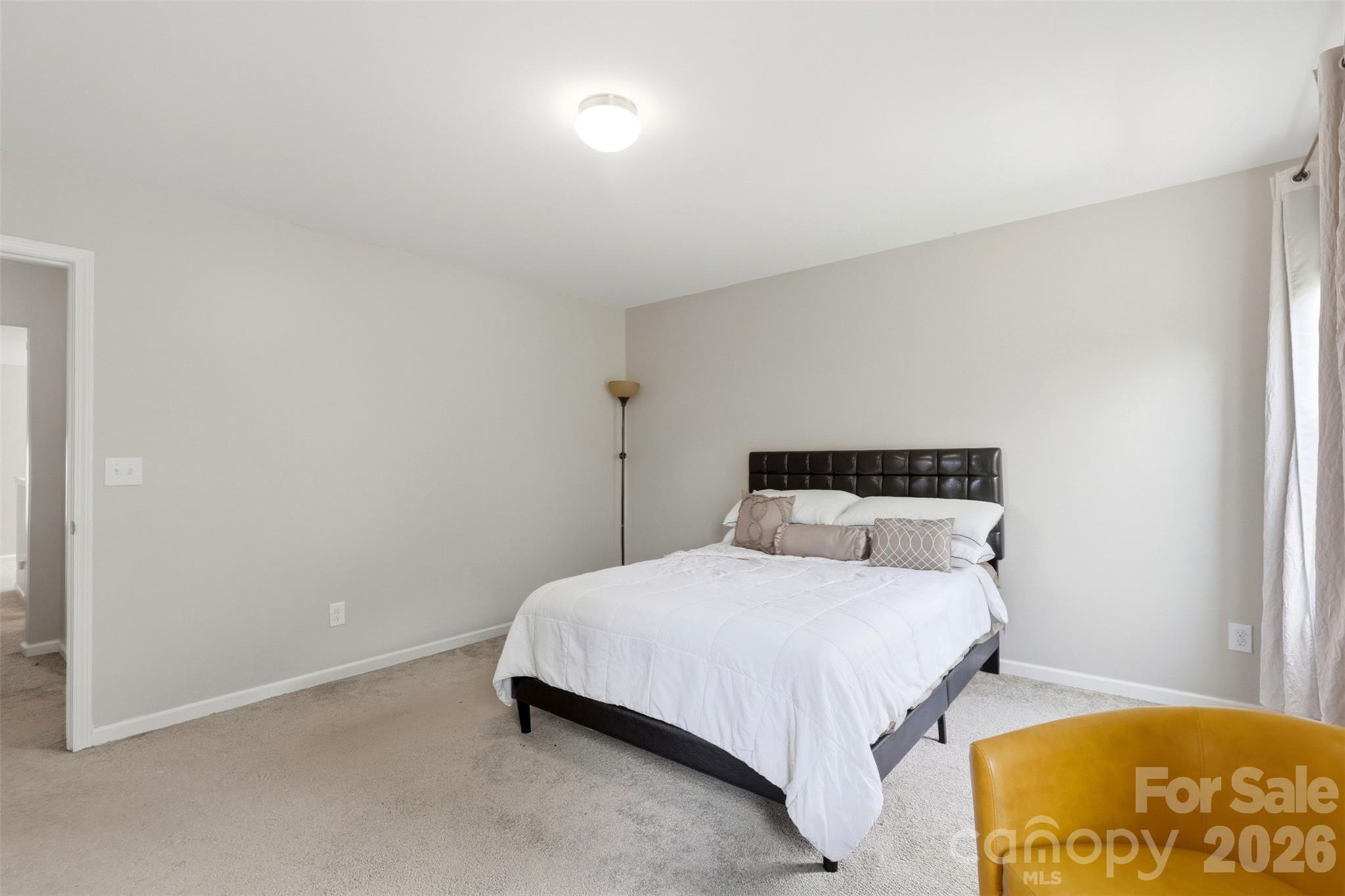 7017 Whitewater Loop Lowell, NC 28098 - Photo 15 of 39 a bedroom with a bed and a lamp