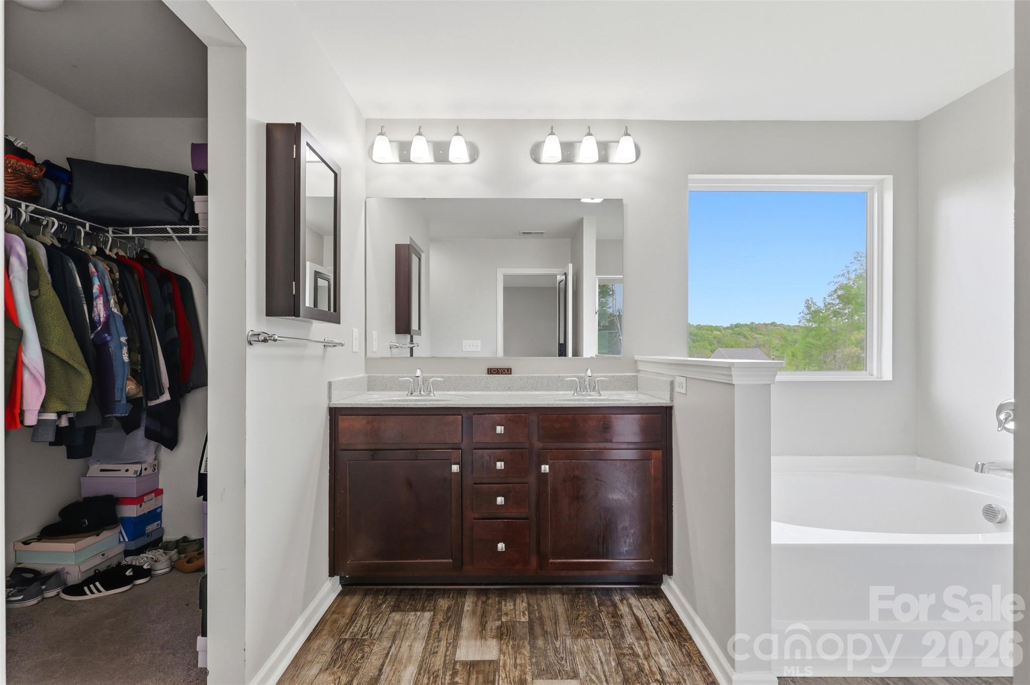7017 Whitewater Loop Lowell, NC 28098 - Photo 17 of 39 a bathroom with a sink a vanity and a mirror
