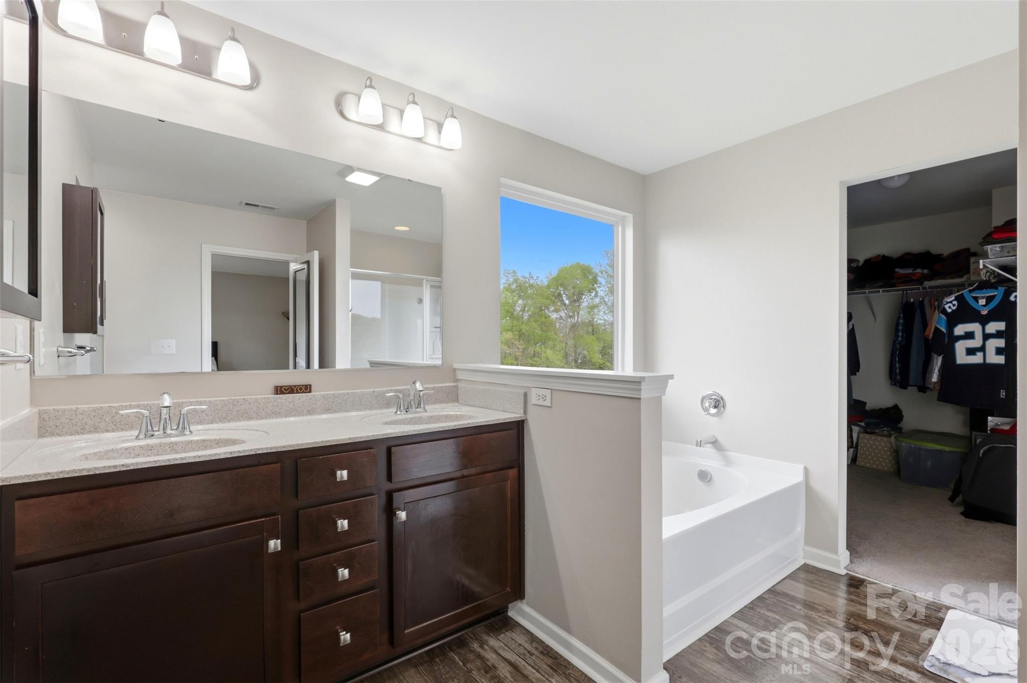 7017 Whitewater Loop Lowell, NC 28098 - Photo 18 of 39 a en suite bathroom with a tub sink and mirror