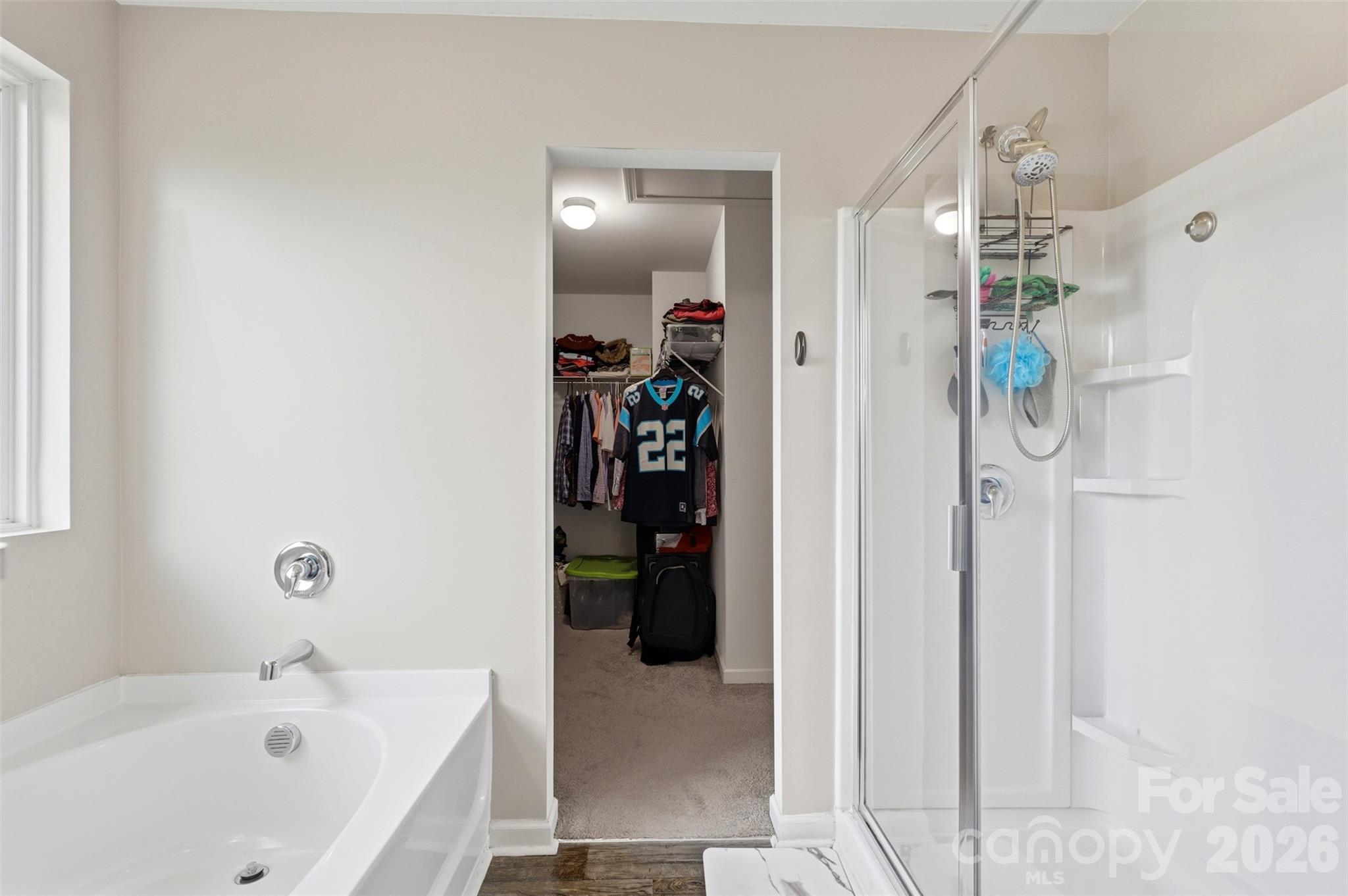 7017 Whitewater Loop Lowell, NC 28098 - Photo 19 of 39 a bathroom with a bathtub and a shower