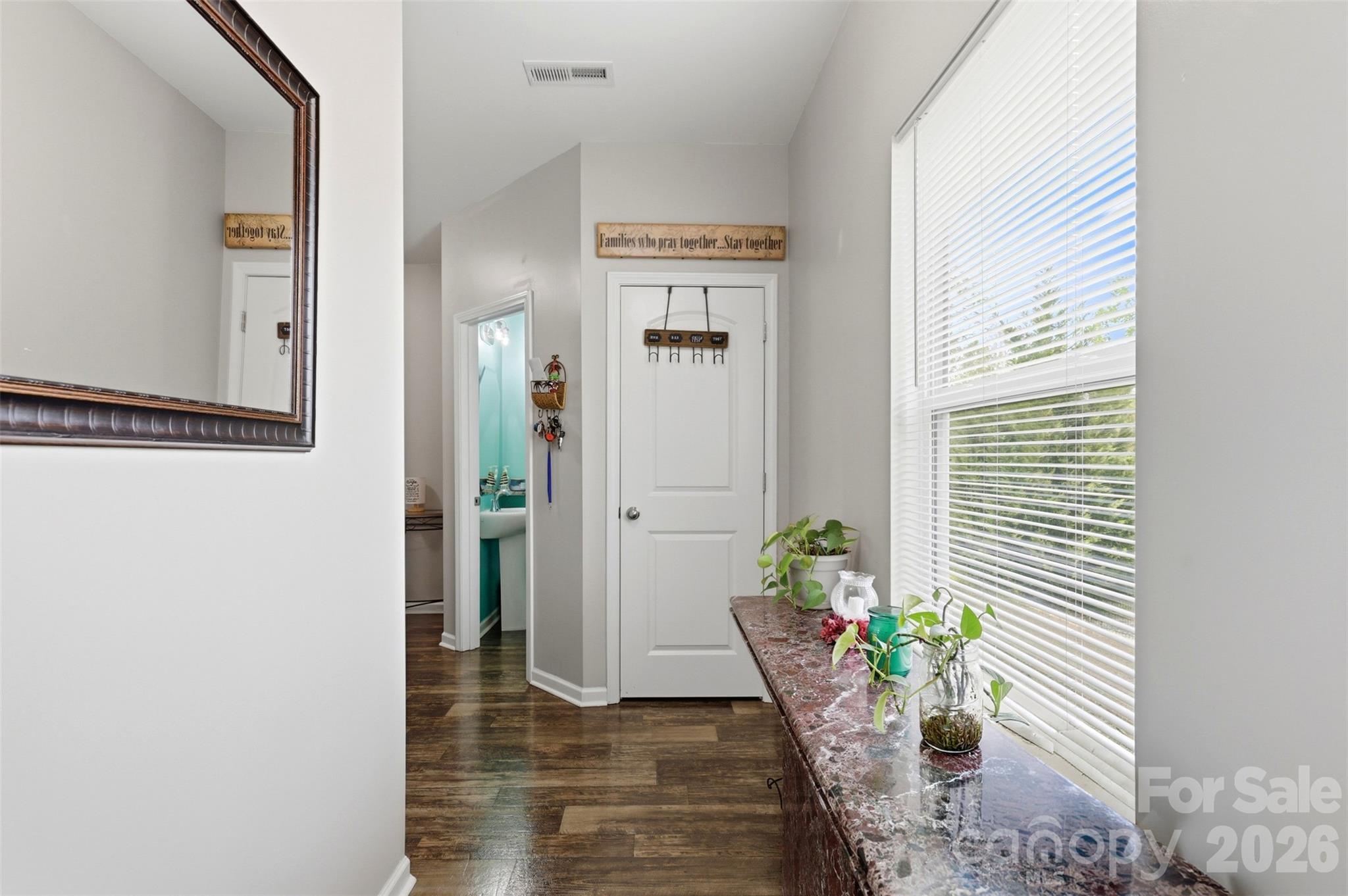 7017 Whitewater Loop Lowell, NC 28098 - Photo 2 of 39 a view of a hallway with wooden floor and a potted plant