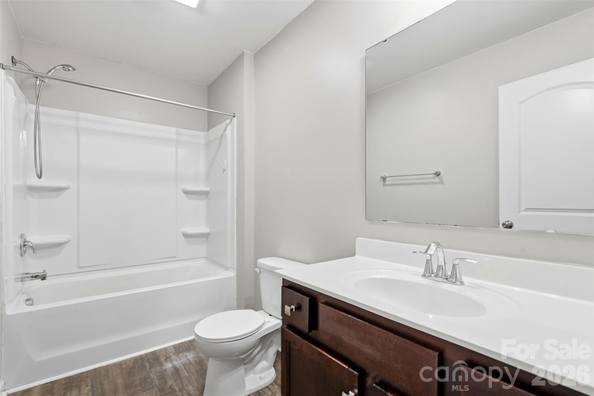 7017 Whitewater Loop Lowell, NC 28098 - Photo 27 of 39 a bathroom with a sink toilet vanity and shower