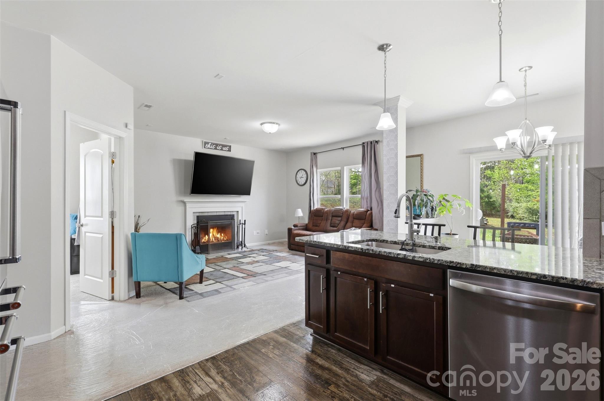 7017 Whitewater Loop Lowell, NC 28098 - Photo 3 of 39 a kitchen with stainless steel appliances granite countertop a sink a stove and a wooden floors