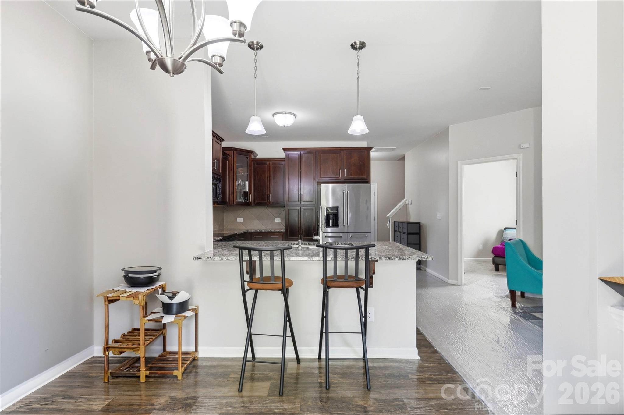 7017 Whitewater Loop Lowell, NC 28098 - Photo 9 of 39 a view of kitchen with furniture and wooden floor
