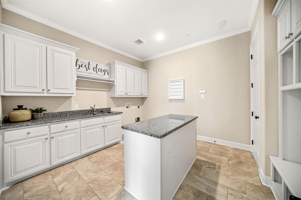 7009 Bach Colleyville, TX 76034 - Photo 21 of 40 Full Utility Room Is Directly Accessible Between Garage & Kitchen