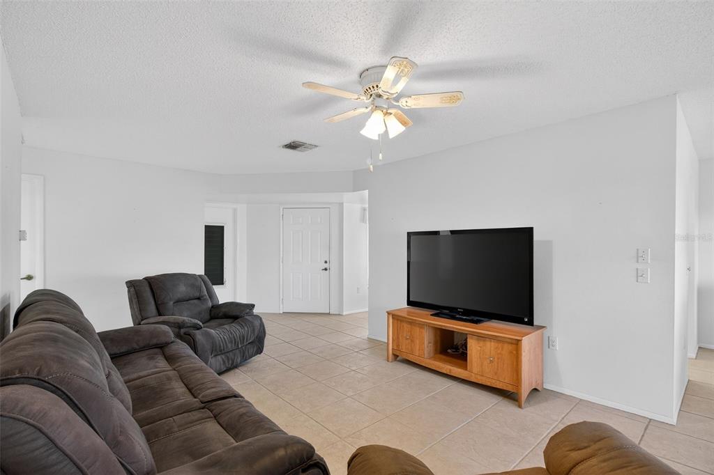 4841 Boonesboro Court New Port Richey, FL 34655 - Photo 14 of 44 a living room with furniture and a flat screen tv