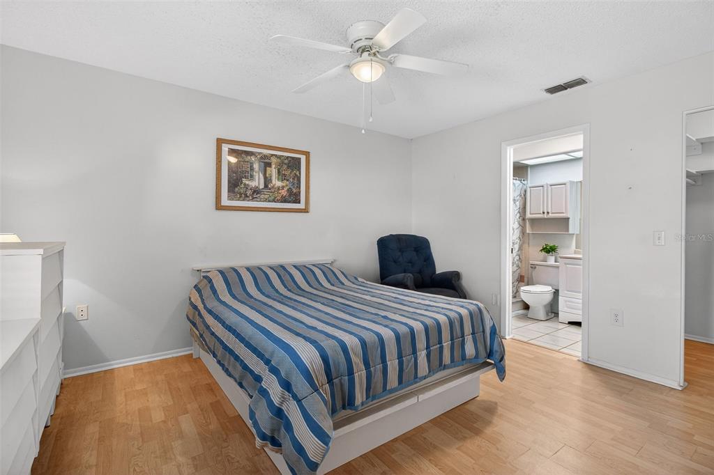 4841 Boonesboro Court New Port Richey, FL 34655 - Photo 16 of 44 a bedroom with a large bed and a chandelier