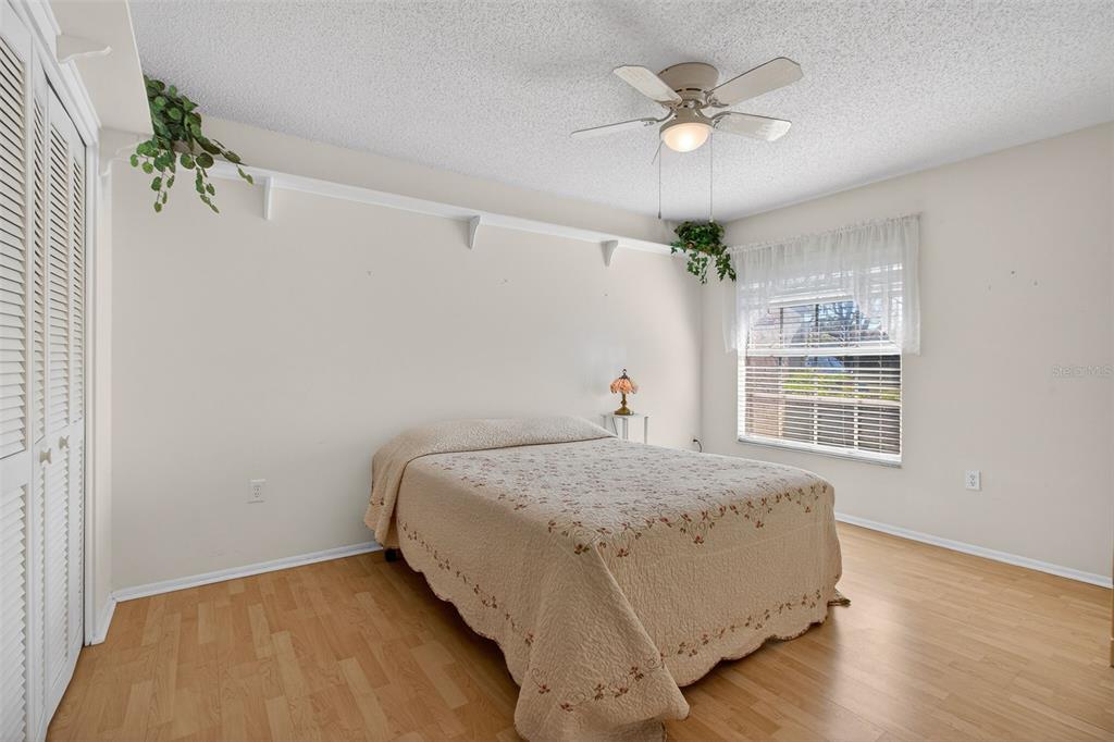 4841 Boonesboro Court New Port Richey, FL 34655 - Photo 20 of 44 a bedroom with a bed and a chandelier