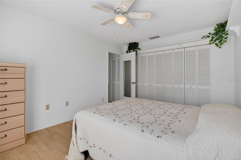 4841 Boonesboro Court New Port Richey, FL 34655 - Photo 21 of 44 a bedroom with a bed and a chandelier