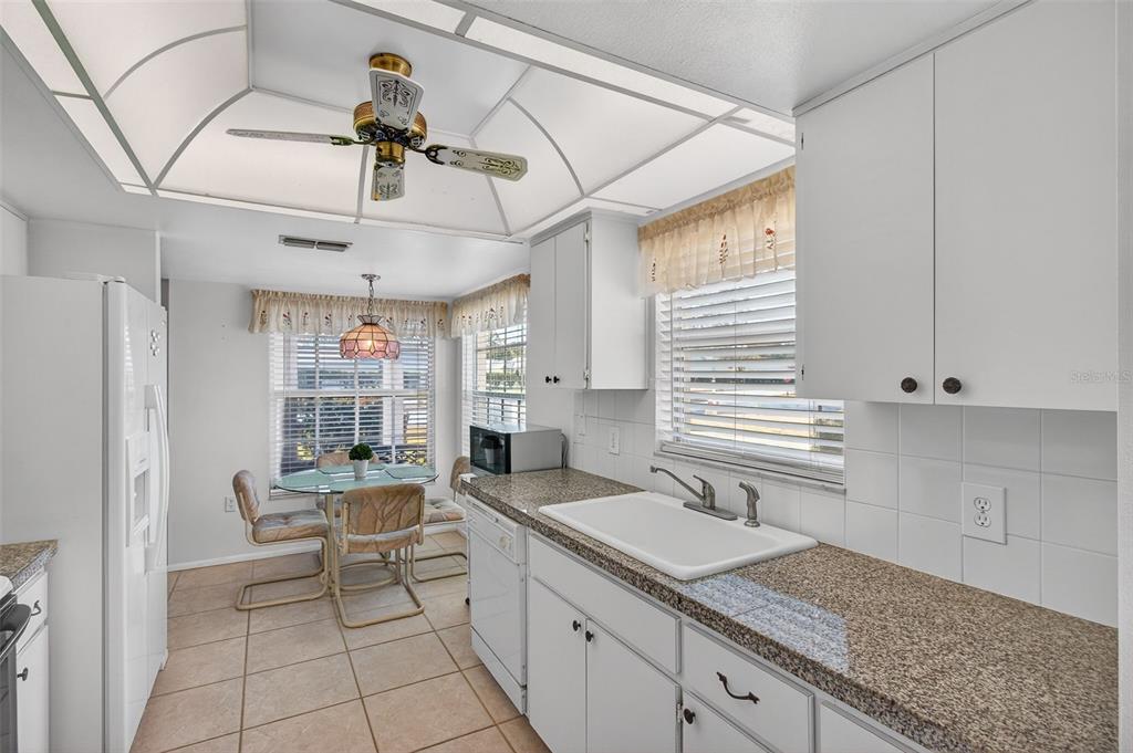 4841 Boonesboro Court New Port Richey, FL 34655 - Photo 9 of 44 a kitchen with a sink cabinets and window