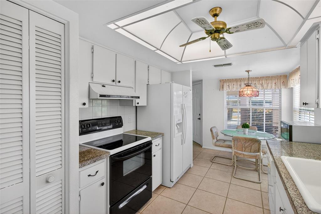 4841 Boonesboro Court New Port Richey, FL 34655 - Photo 10 of 44 a kitchen with a stove a chandelier and a sink