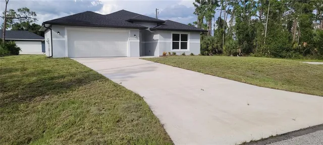 a front view of a house with a garden