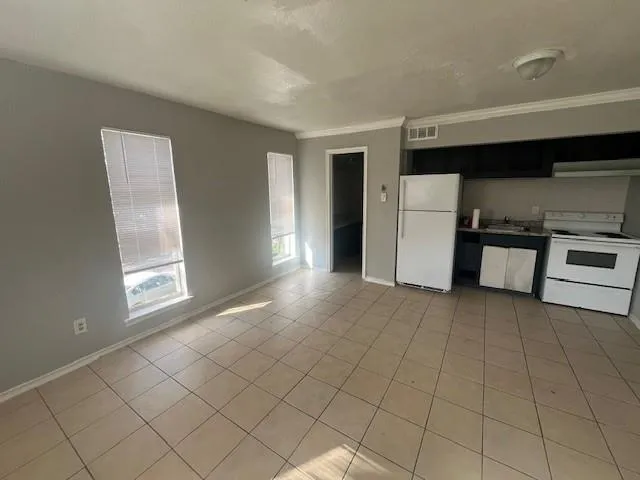 a view of a kitchen with a sink dishwasher and a refrigerator