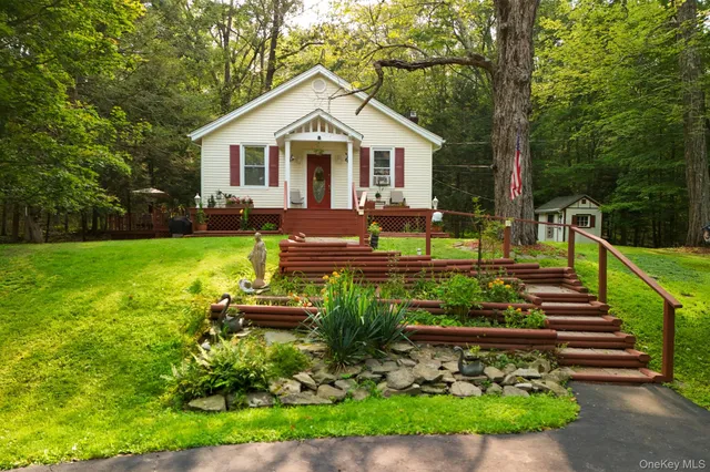 a front view of a house with a yard table and chairs
