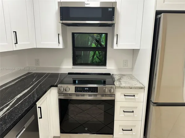 a stove top oven sitting inside of a kitchen