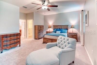 824 Ebb Tide Lane Kissimmee, FL 34759 - Photo 13 of 60 a bedroom with furniture and a fireplace