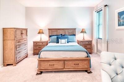 824 Ebb Tide Lane Kissimmee, FL 34759 - Photo 14 of 60 a bedroom with a bed and a cabinets