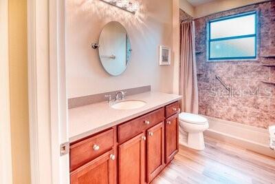 824 Ebb Tide Lane Kissimmee, FL 34759 - Photo 25 of 60 a bathroom with a sink a toilet and a mirror