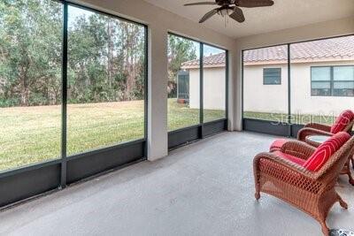 824 Ebb Tide Lane Kissimmee, FL 34759 - Photo 27 of 60 a living room with furniture and a floor to ceiling window