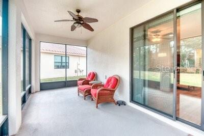 824 Ebb Tide Lane Kissimmee, FL 34759 - Photo 29 of 60 a living room with furniture and a floor to ceiling window
