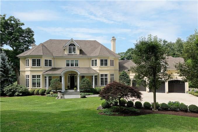 a front view of a house with a garden and plants